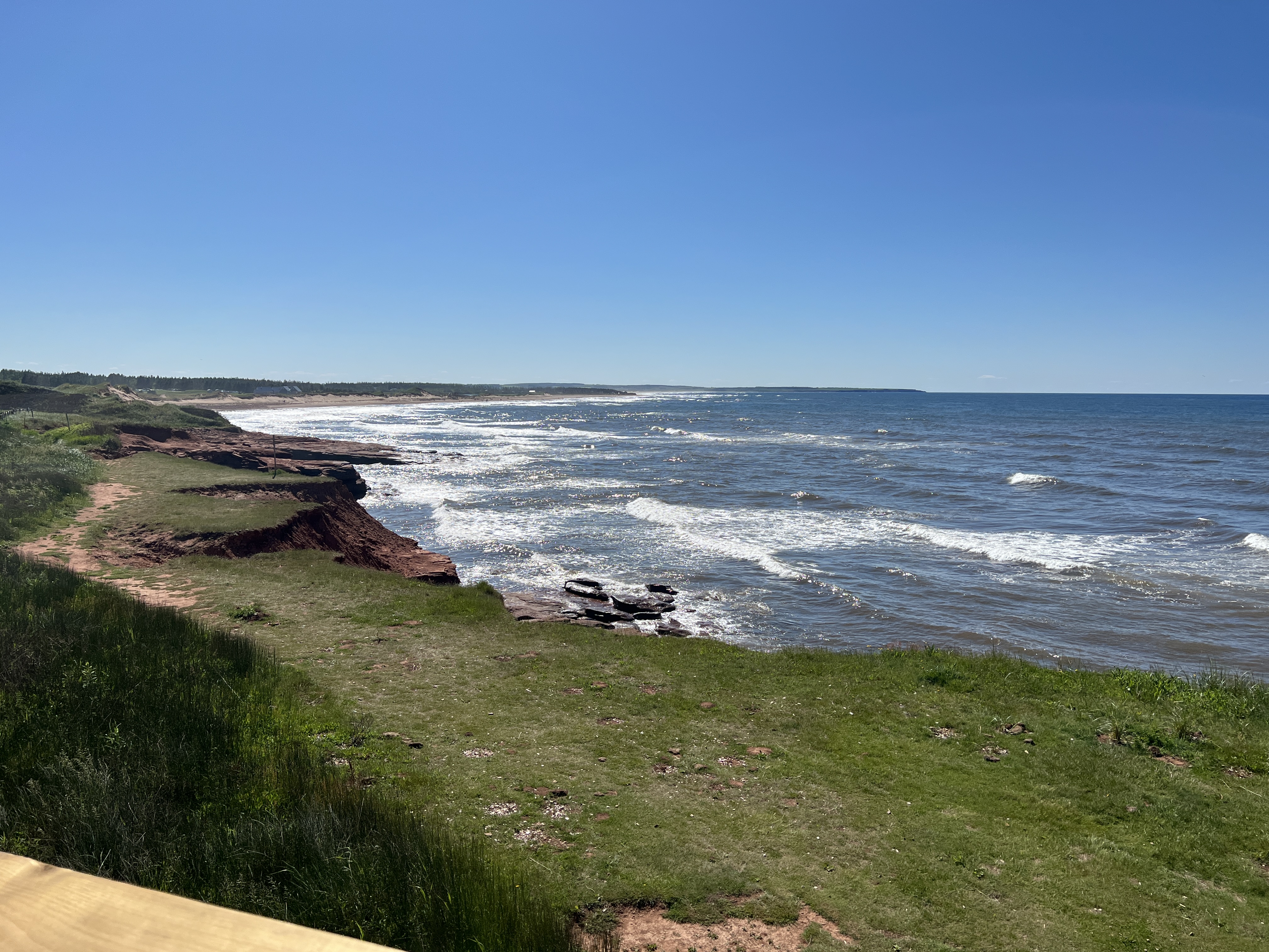 shoreline The green grass and red sandstone cliffs embrace the blue sea along Prince Edward Island’s North Shore. Photo by Julie A. Sellers.