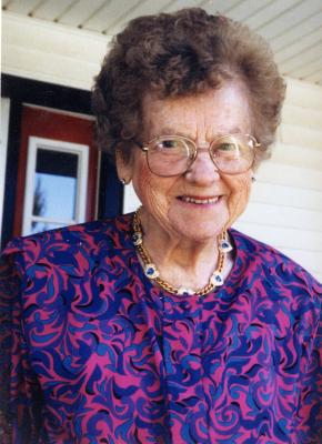 Leta Andrew A woman with short brown hair wearing a purple patterned shirt.