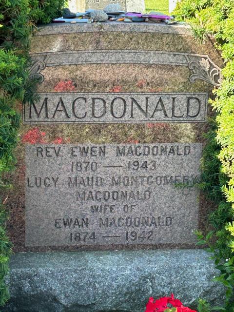 A close-up of the tombstone marking the final resting place of Montgomery and her husband, showing name and date information about them.