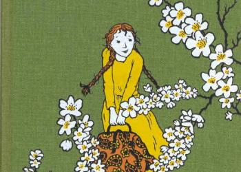 Illustration of Anne wearing a yellow dress and surrounded by white blossoms, printed on green bookcloth.