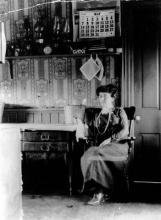 black and white image of Montgomery seated in a kitchen